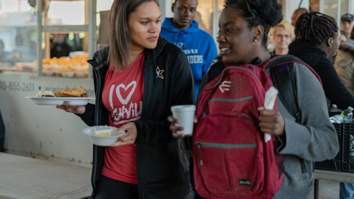 Serving Meals under the The Bridge  logo